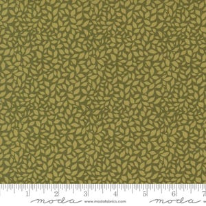 以下が含まれることがあります： 小さな薄い緑の葉の繰り返しパターンを持つ緑色の生地。生地はスケール用の定規と一緒に表示されています。