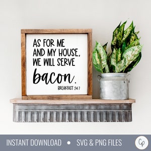 May include: A framed wooden sign with the text "AS FOR ME AND MY HOUSE, WE WILL SERVE bacon. BREAKFAST 24:7" in black lettering. The sign is on a shelf with a metal container holding green plants.