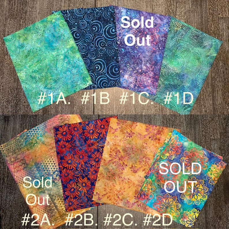 May include: Eight fabric squares with different patterns. The top row has a teal, blue, purple, and green square. The bottom row has a gold, red, orange, and blue square. The text "Sold Out" is on the top row and the bottom row. The squares are labeled #1A, #1B, #1C, #1D, #2A, #2B, #2C, and #2D.