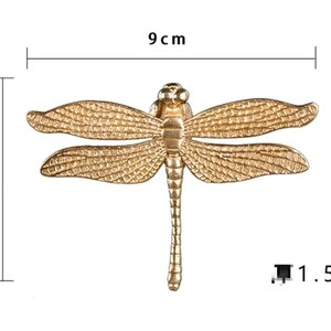 Puede incluir: Lib&eacute;lula de metal dorado con alas detalladas, que mide 9 cm de ancho y 6,5 cm de alto. La lib&eacute;lula tiene un cuerpo de 1,5 cm de largo.
