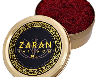 May include: A gold metal tin with a black label that reads "Zaran Saffron" and "28g Pure Spanish Saffron". The tin is open and filled with red saffron threads.