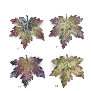 May include: Four different colored maple leaf shaped metal ornaments. The leaves are in shades of green, purple, and brown. The leaves are arranged in a grid pattern with the labels P1, P2, P3, and P4.