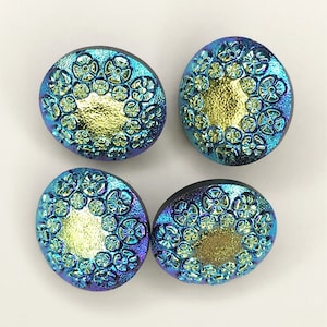 May include: Four iridescent glass buttons with a gold center and a blue and green floral design.