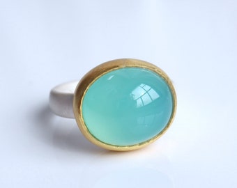 small paraiba blue chalcedony ring made of silver and 900 gold, cabochon ring turquoise, stone pool blue in silver ring with 22k setting