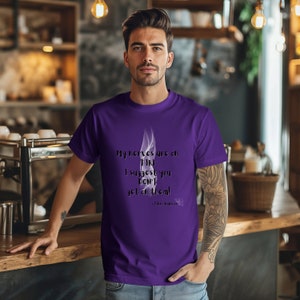 May include: A purple t-shirt with a white smoke graphic and the text "My nerves are on FIRE I suggest you DON'T get on them! - Edina Warmer".