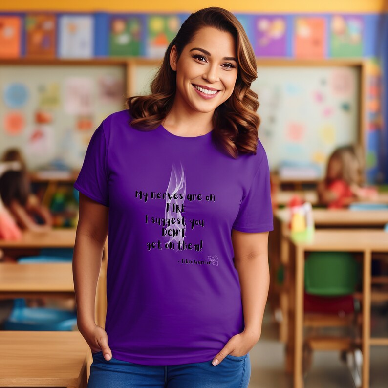 May include: Purple t-shirt with a white smoke design and the text "My nerves are on FIRE I suggest you DON'T get on them!"  - Fibre Warrior