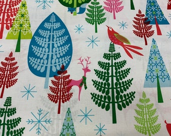 May include: A white fabric with a repeating pattern of stylized Christmas trees in various colors, including green, red, blue, and pink. The trees are decorated with snowflakes and other wintery motifs.