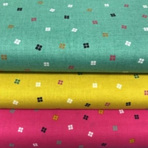 May include: Four fabric swatches with a repeating pattern of small squares in various colours, including green, yellow, pink, and teal.