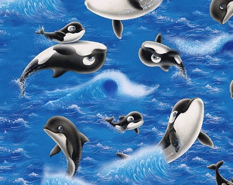 May include: A blue and white fabric with a repeating pattern of black and white orcas swimming in blue water with white waves. The orcas are in various positions, some are jumping out of the water, some are swimming in the water, and some are swimming in the waves.