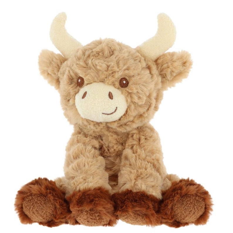 May include: A plush Highland cow toy with a light brown body, darker brown hooves, and cream-colored horns. The stuffed animal has a smiling face with brown eyes and a white muzzle. The toy is designed to sit upright.