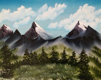 May include: A painting of a mountain range with snow-capped peaks and a blue sky with white clouds. The mountains are dark green and purple, and the foreground is a field of green grass.
