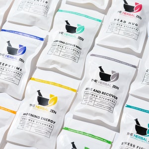 May include: A variety of white pouches with black text and a mortar and pestle logo. The pouches are labeled with different scents, including "Tropical Refresh", "Sleepytime", "Morning Citrus Mint", "Morning Energy", "Head Hug", "Rise and Recover", "Cold Kicker", and "Stress Fighter".