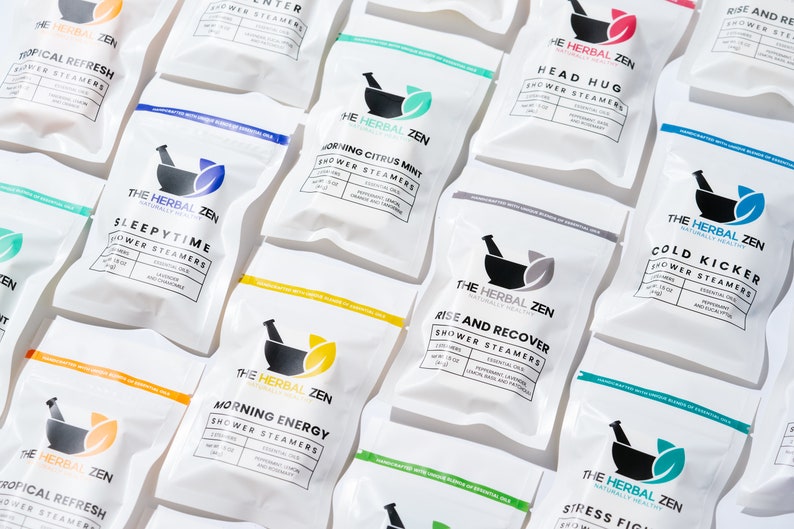 May include: A variety of white pouches with black text and a mortar and pestle logo. The pouches are labeled with different scents, including "Tropical Refresh", "Sleepytime", "Morning Citrus Mint", "Morning Energy", "Head Hug", "Rise and Recover", "Cold Kicker", and "Stress Fighter".