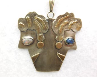 Gold and sterling Silver contemporary /folk art black opal lady heads pendant