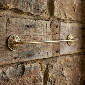 Solid brass towel bar mounted on rustic wood wall handmade bathroom hardware