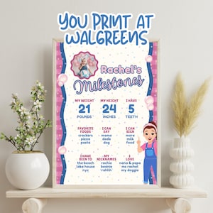 Puede incluir: Un póster de hitos personalizado con un diseño rosa y azul. El póster incluye el texto "Rachel's Milestones", un peso de 9,5 kg, una altura de 61 cm y 5 dientes. También enumera comidas favoritas, cosas que el niño puede decir y apodos. El texto "You print at Walgreens" está en la parte superior.