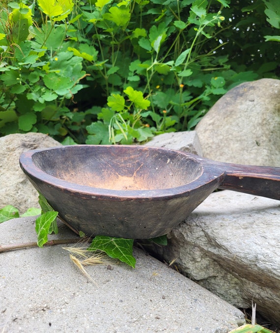 Genuinely antique Bulgarian primitive bowl with deep folk-craft history baked into its carved surface — not a reproduction.