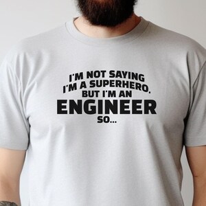 May include: A grey t-shirt with the text "I'm not saying I'm a superhero, but I'm an engineer so..." printed in black.