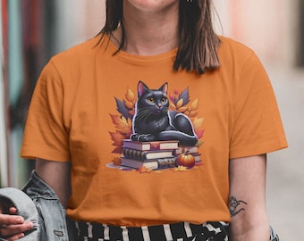 Book Lover Fall Shirt, Black Cat On Top of A Pile Of Books Surrounded By Fall Leaves, Cozy Autumn Reading Tee for Book Lovers