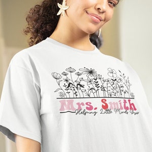 Personalized back to school shirt for teacher, helping little minds grow, multiple colour options for lettering, wildflowers, Gildan 5000