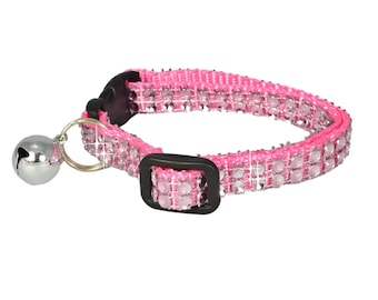 May include: Pink cat collar with a silver bell and clear rhinestones.