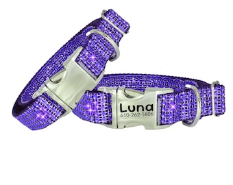 May include: Two purple pet collars covered in small, sparkling rhinestones. Each collar features a silver-toned metal side-release buckle. One buckle is engraved with the name Luna and the phone number 610-262-5806 in a black sans-serif font.