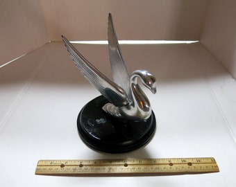 With stand:  Full size cast Aluminum Packard swan Hood Ornament, on wooden stand.  6.75" tail to beak, , 6.5" wood base.