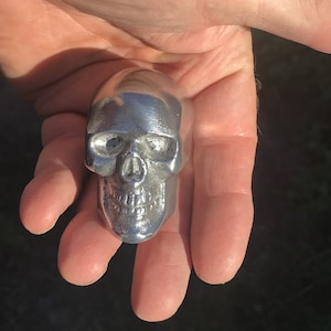 one ALUMINUM Very Small Skull Hood Ornaments, with bolt on bottom.  1.5&quot; wide.