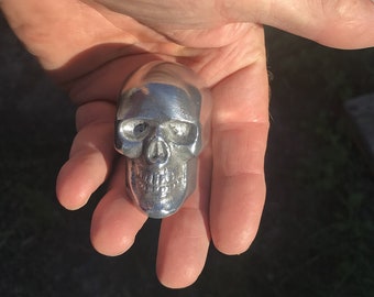 one ALUMINUM Very Small Skull Hood Ornaments, with bolt on bottom.  1.5" wide.