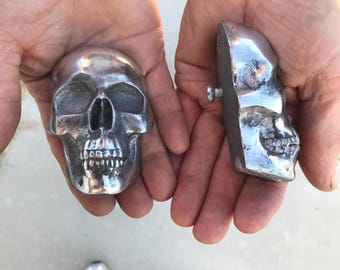 one ALUMINUM half Skull Hood Ornament, with bolt on back.  2 1/4" wide.