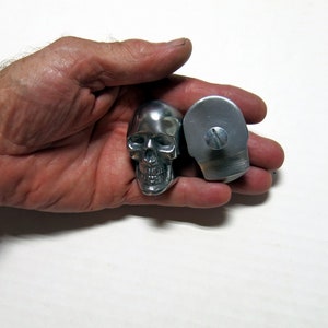 One Very Small Skull Hood ornament, polished aluminum, with bolt on flat back.  2 1/8" tall.