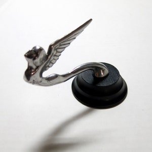 1930&#39;s Plymouth Winged Lady Hood Ornament, cast aluminum, with bolt on back.  4.75&quot; long, on a Black wooden stand.  Half scale.