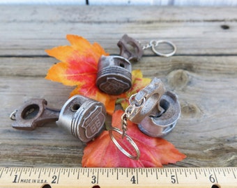 Route 66, 2 (two) Rusty looking Aluminum piston keychains miniature 1/3 scale.