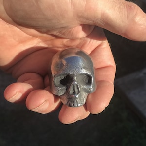 one ALUMINUM Very Small Half-Skull Hood Ornaments, with bolt on back.  1.5&quot; wide.