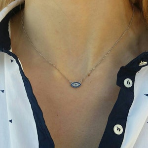 Model wearing A silver evil eye necklace with blue zircon hanging on a 925 sterling silver chain. It is elegant, dainty and still eye catching!

Ideal for bridesmaid gift or anniversary gift.