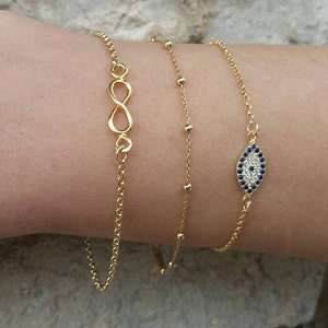 Model wearing an Evil eye bracelet, made of cubic zirconia beads and high quality, 14k gold plated chain. Appropriate for both formal or everyday looks.
Also available in 925 sterling silver. 
Ideal bridesmaid or anniversary gift.