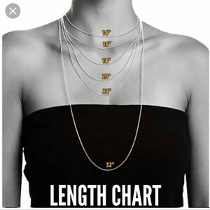 May include: A length chart for necklaces, showing different lengths from 14 inches to 32 inches. The chart is displayed on a model wearing a black top.