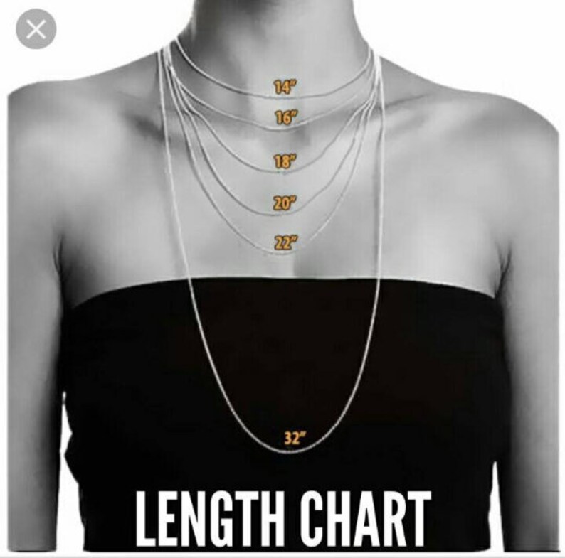 May include: A length chart for necklaces, showing different lengths from 14 inches to 32 inches. The chart is displayed on a model wearing a black top.