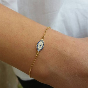 Model wearing an Evil eye bracelet, made of cubic zirconia beads and high quality, 14k gold plated chain. Appropriate for both formal or everyday looks.
Also available in 925 sterling silver. 
Ideal bridesmaid or anniversary gift.