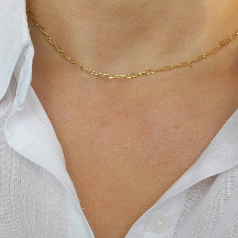 Model wearing A brilliant 14k gold filled layered necklace set, combined from a 14k gold filled link chain necklace and a shinny cross necklace. 
Length approx. 16 inches - can be adjusted upon request.