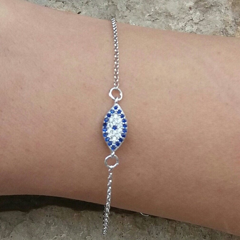 Model wearing an Evil eye bracelet, made of cubic zirconia beads and high quality, 14k gold plated chain. Appropriate for both formal or everyday looks.
Also available in 925 sterling silver. 
Ideal bridesmaid or anniversary gift.