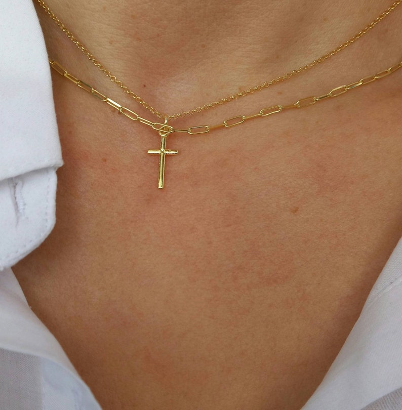 Model wearing A brilliant 14k gold filled layered necklace set, combined from a 14k gold filled link chain necklace and a shinny cross necklace. 
Length approx. 16 inches - can be adjusted upon request.