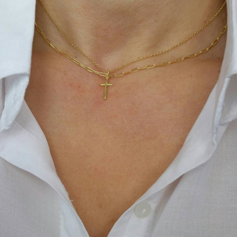 Model wearing A brilliant 14k gold filled layered necklace set, combined from a 14k gold filled link chain necklace and a shinny cross necklace. 
Length approx. 16 inches - can be adjusted upon request.