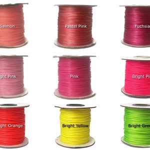 May include: Nine spools of waxed cotton cord in various colors, including salmon, pastel pink, fuchsia, light pink, pink, bright pink, bright orange, bright yellow, and bright green.