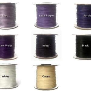 May include: Nine spools of waxed cotton cord in various colors, including lilac, light purple, purple, dark violet, indigo, black, white, and cream.