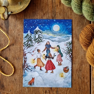 May include: A watercolor painting depicts a winter scene with figures dancing in a circle, holding lanterns. The artwork features a snowy landscape, a full moon, and a starry sky. A fox stands in the foreground. The figures wear colorful clothing.