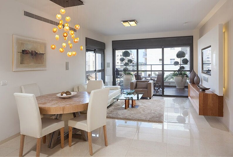 Sophisticate Reef Chandelier with Amber pendants over dining room table on rectangular canopy
