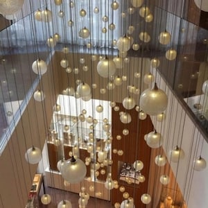 Amazing-staircase-SNOW LIGHT- modern-blown-glass-chandelier, beautiful-custom-lighting, amazing-dining-chandelier, stairwell-pendant-light