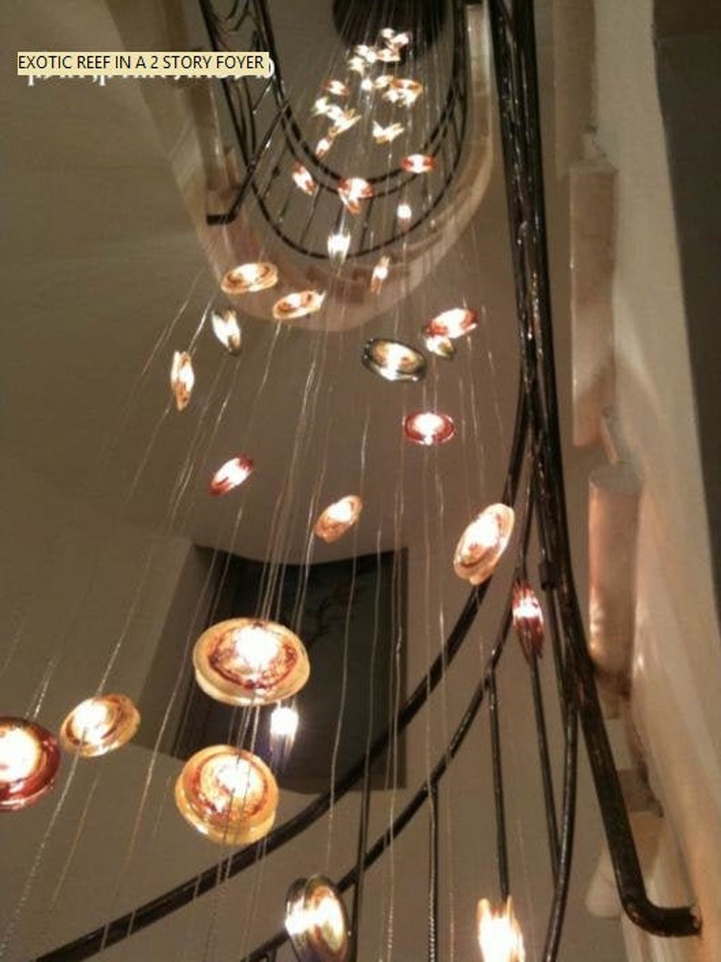 Enchanting multi color Reef Chandelier in staircase on circular canopy
