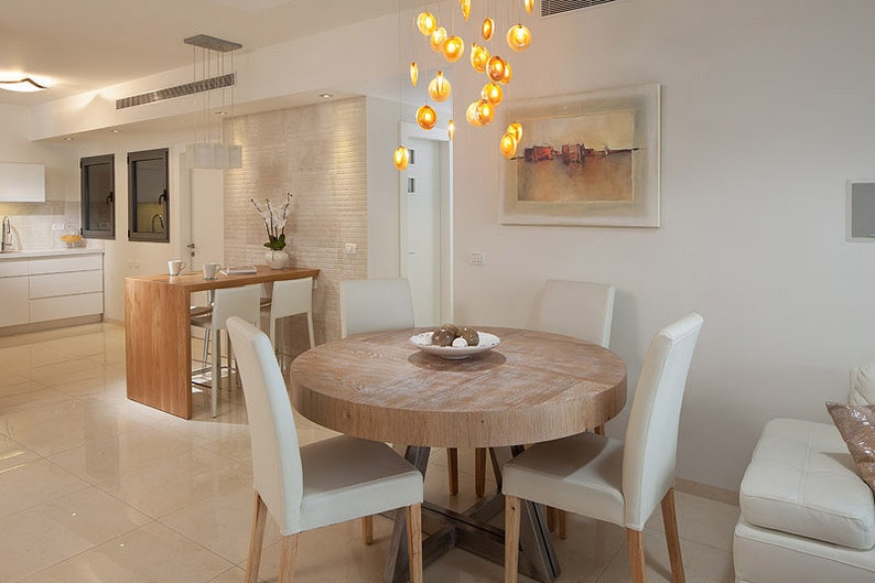 Sophisticate Amber colored Reef Chandelier over dining room table on circular canopy